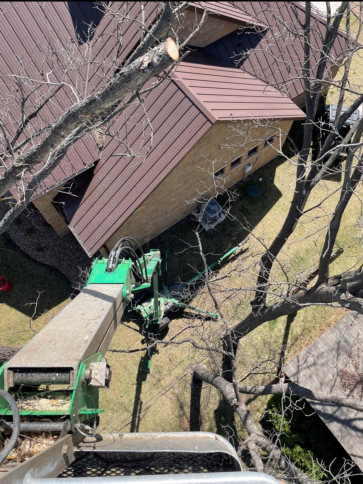 Aerial view from bucket crane during tree removal in Lampasas TX