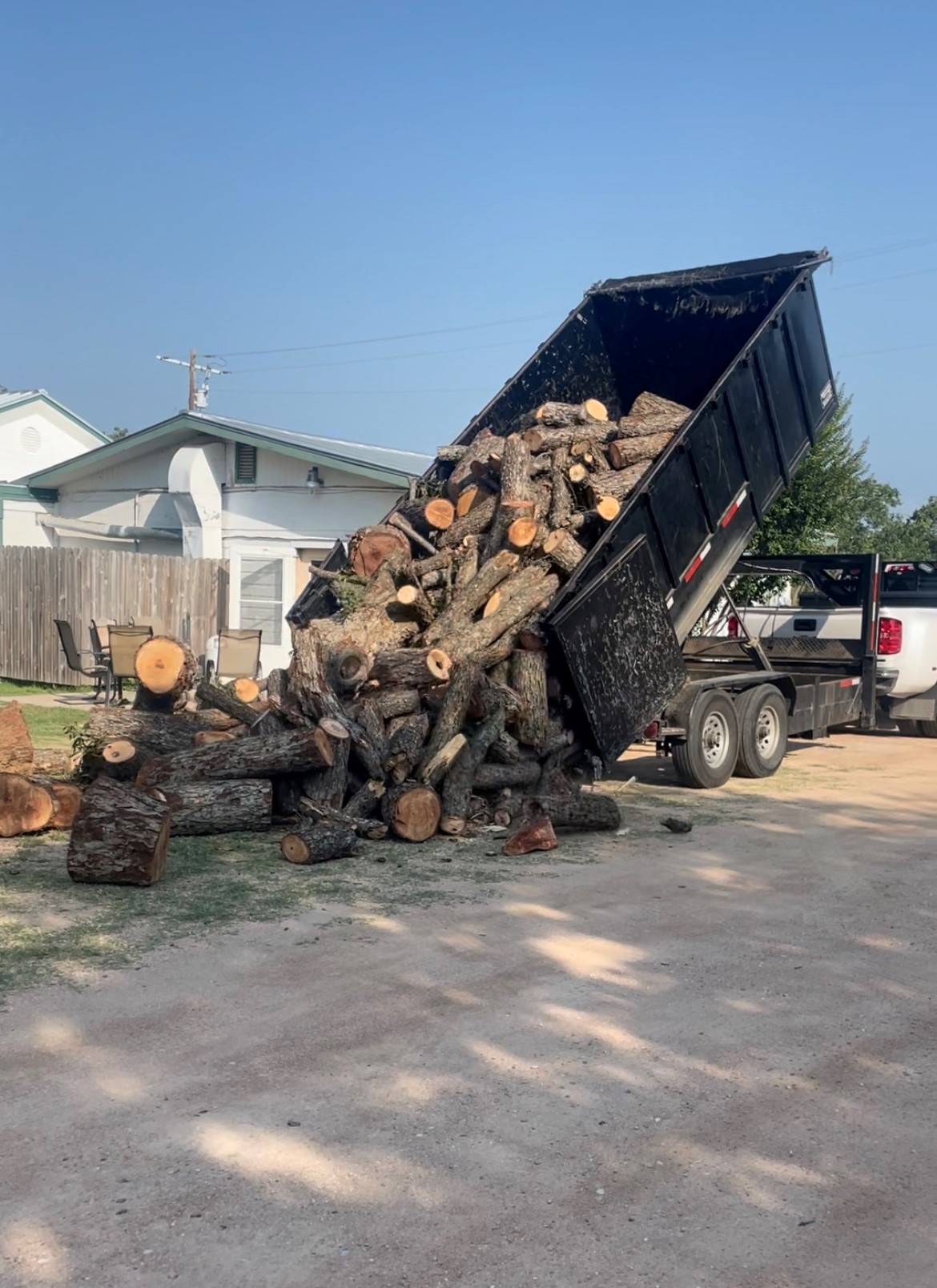 CAT skid steer clearing land near Marble Falls TX